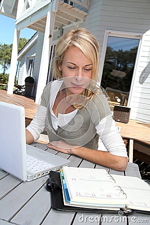 Woman teleworking on laptop Stock Photo