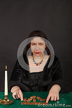A woman is telling the future with runes Stock Photo
