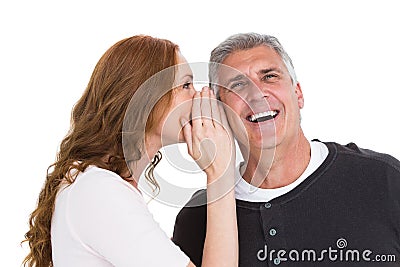 Woman telling secret to her partner Stock Photo