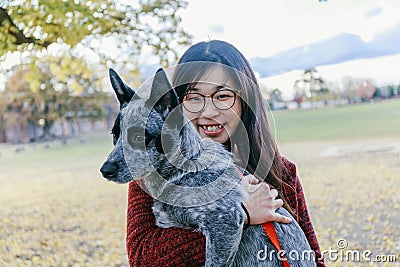 Woman Tenderly Hugging and looking at her Pet Australian doggy Stock Photo