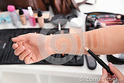 Woman testing different shades of skin foundation Stock Photo