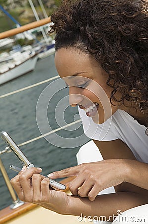 Woman Text Messaging Through Cell Phone Stock Photo