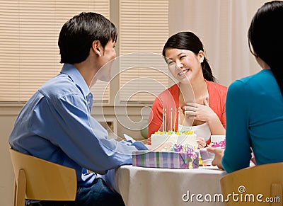 Woman thanking husband for birthday cake Stock Photo