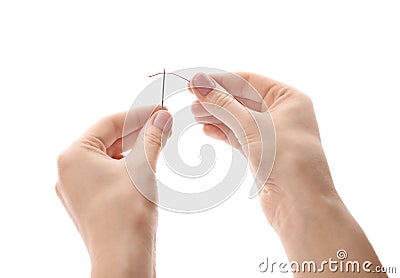 Woman threading needle on background Stock Photo