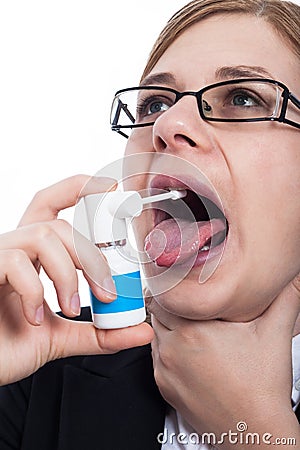 Woman with throat pain using oral spray Stock Photo