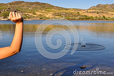 Woman Throwing a Stone Stock Photo