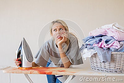 Woman tired and exhausted by housekeeping jobs Stock Photo