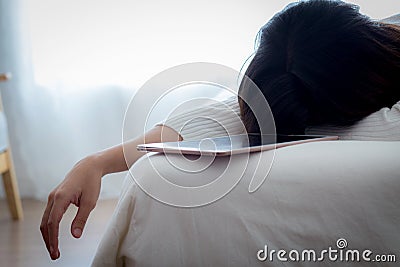 Woman tired work with sleeping - work hard too with tablet beside Stock Photo