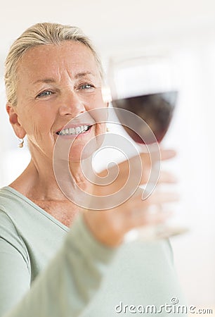 Woman Toasting Wineglass At Home Stock Photo