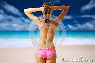 Woman topless on beautiful beach at Seychelles Stock Photo