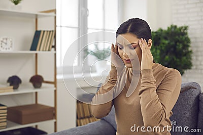 Woman touching her temples, suffering from stress, bad headache or severe migraine Stock Photo