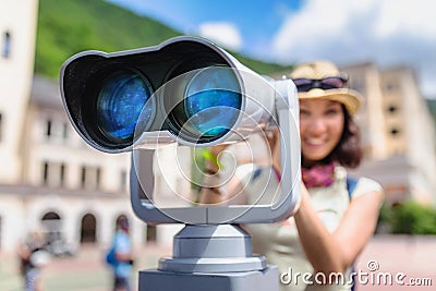 Tourist admiring the views of the resort architecture of the city through a street telescope Stock Photo