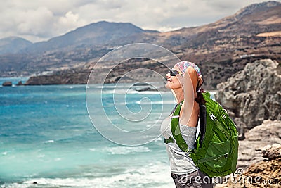 Woman tourist backpacker enjoying journey, unity with nature. Stock Photo