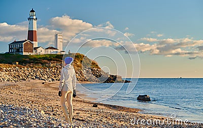 Woman tourist at the beach near Montauk Lighthouse Stock Photo