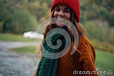 Woman Tourist green scarf sweater Red hat travel autumn fresh air Stock Photo