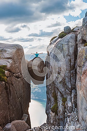 Woman tourist on Kjeragbolten Travel Norway Kjerag mountains Stock Photo