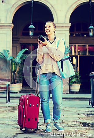 Woman tourist photographing the street Stock Photo