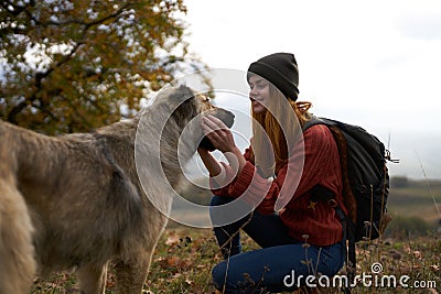 woman tourist playing dog nature landscape friendship Stock Photo