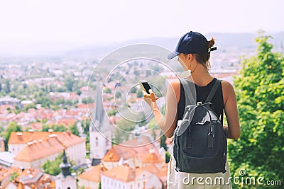 Woman with smartphone in hand on background of Ljubljana City, S Stock Photo