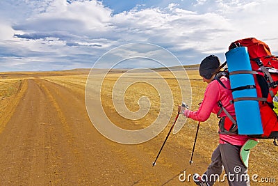 Woman tourist walking on a gravel road Olkhon Island Stock Photo