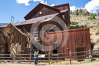 Woman tourists explores the old mining ghost town of Bayhorse Idaho in the Salmon-Challis National Forest Stock Photo