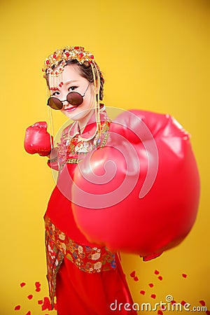 Woman in traditional Chinese costume and boxing gloves Stock Photo