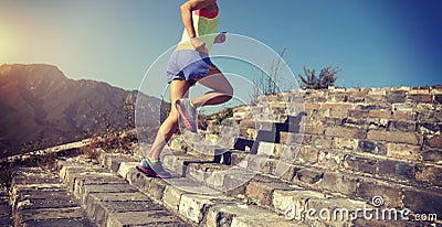 Runner running upstairs on the great wall top of mountain Stock Photo