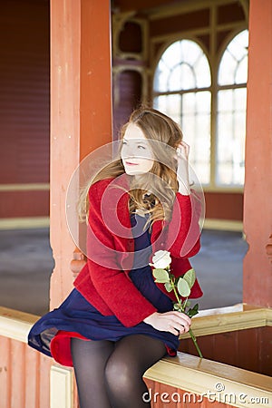 Woman at train station sit on boundaries Stock Photo