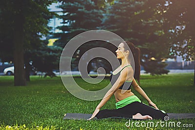 Woman training yoga in twisting sage pose. Stock Photo