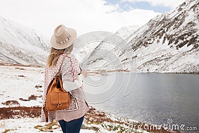 Woman traveler on the background of a mountain lake Stock Photo