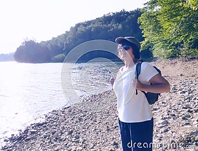 A woman traveler with a backpack walks Stock Photo