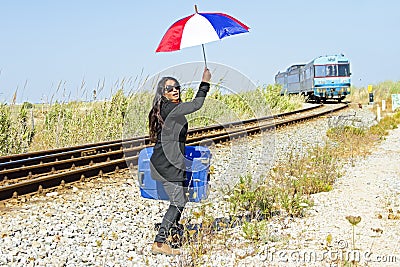 Woman traveler at a passing train Stock Photo