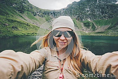 Woman traveler taking selfie hiking in mountains Travel Lifestyle adventure Stock Photo