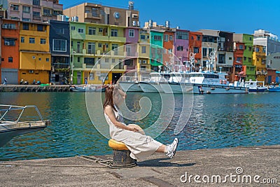 woman traveler visiting in Taiwan, Tourist with hat sightseeing in Keelung, Colorful Zhengbin Fishing Port, landmark and popular Editorial Stock Photo