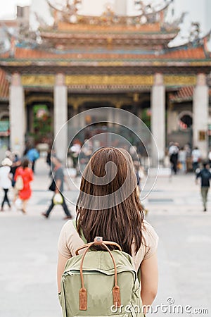 woman traveler visiting in Taiwan, Tourist with hat sightseeing in Longshan Temple, Chinese folk religious temple in Wanhua Stock Photo