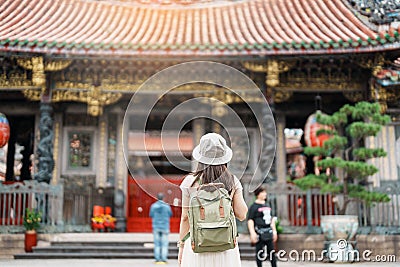 woman traveler visiting in Taiwan, Tourist with hat sightseeing in Longshan Temple, Chinese folk religious temple in Wanhua Stock Photo