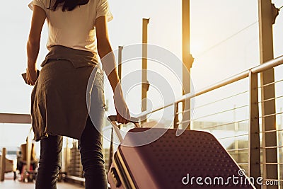 Woman traveler waiting airplane after booking ticket flight at airport Stock Photo