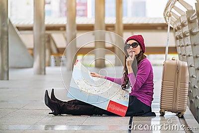 Woman traveller looking at travel map Stock Photo