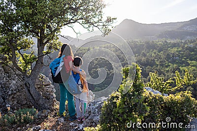 woman travels with a child, A boy and his mother look at the mountains. Hiking and adventures with children Stock Photo