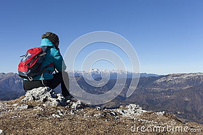 Woman trekker resting in mountains Stock Photo