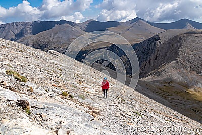 Woman trekking on mystical hiking trail leading to Mount Olympus (Mytikas, Skala, Stefani) in Mt Olympus National Park Stock Photo