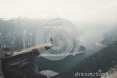 Woman On Trolltunga, The Famous place in Norway, View On Trolltunga And Mountain Landscape, Odda, Norway Stock Photo