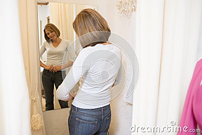 Woman trying on jeans and smiling Stock Photo