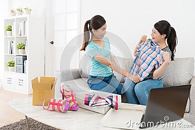 Woman trying new shirt checking whether suitable. Stock Photo
