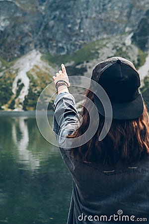 woman trying reach out the sky landscape view of lake at mountains Stock Photo