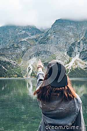 woman trying reach out the sky landscape view of lake at mountains Stock Photo