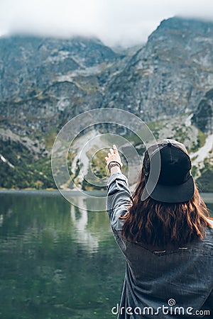 woman trying reach out the sky landscape view of lake at mountains Stock Photo