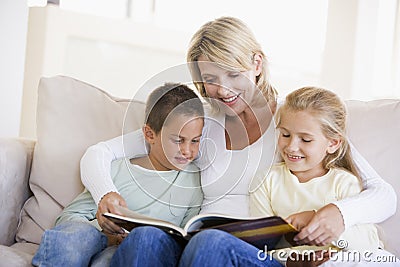 Woman and two children sitting in living room Stock Photo