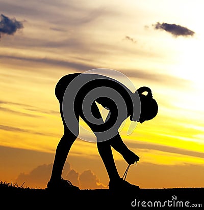 Woman tying shoelaces Stock Photo