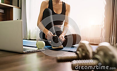 Woman tying shoes.A person running in tracksuit tying her shoelaces Stock Photo